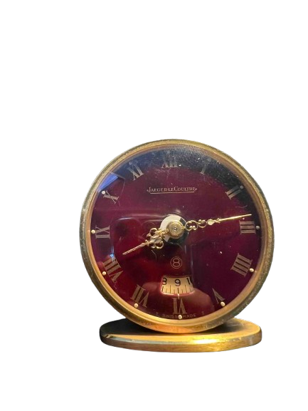 Réveil de voyage Jaeger-LeCoultre, modèle en laiton doré avec cadran rouge bordeaux et chiffres romains